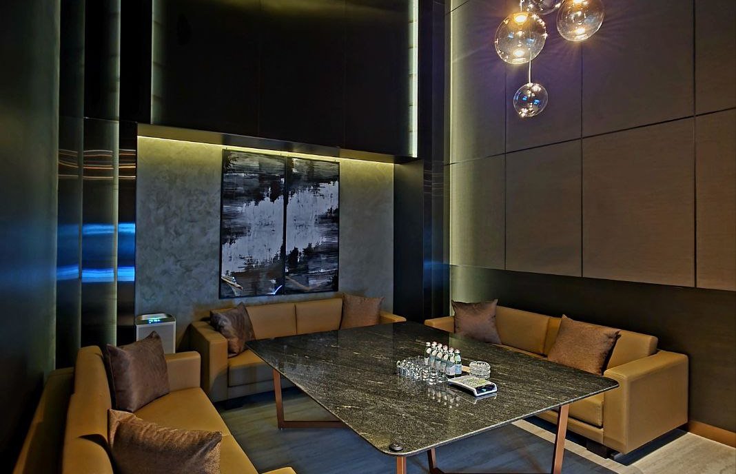 A high-end private karaoke room with premium seating, rich lighting, and an intimate atmosphere designed for VIP guests before and after arena events.