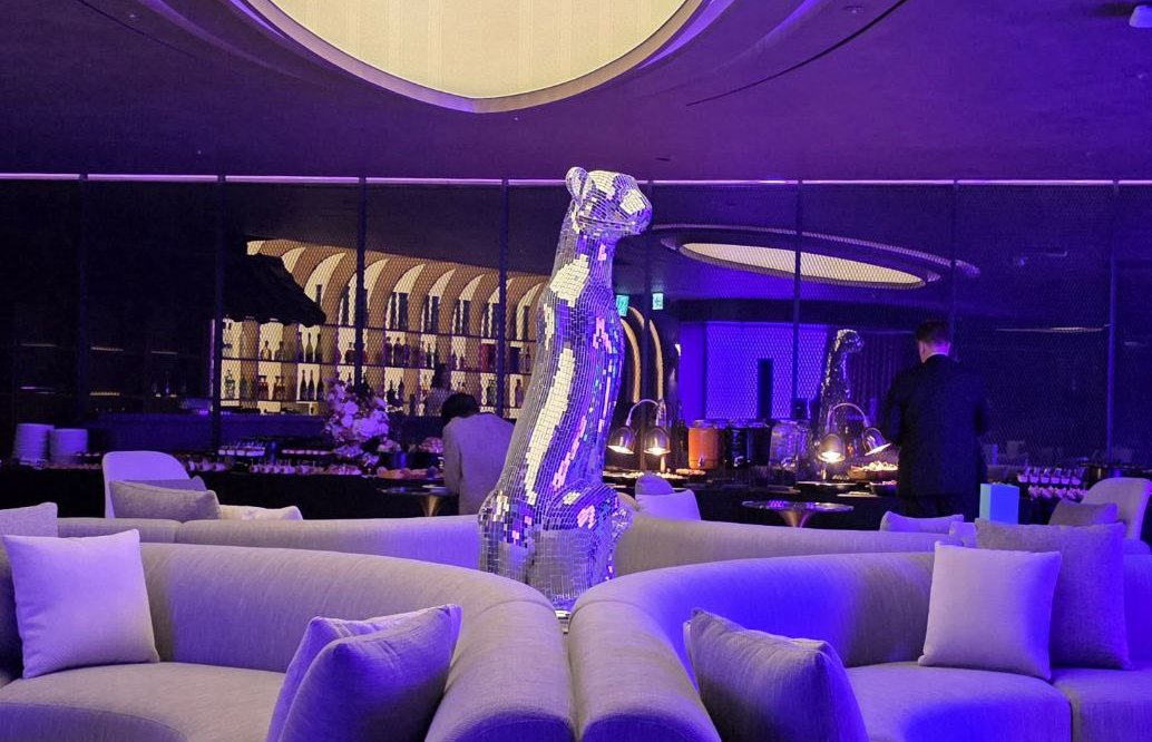 Sapphire Lounge—plush curves, violet glow, and a mirrored centerpiece that steals the room.