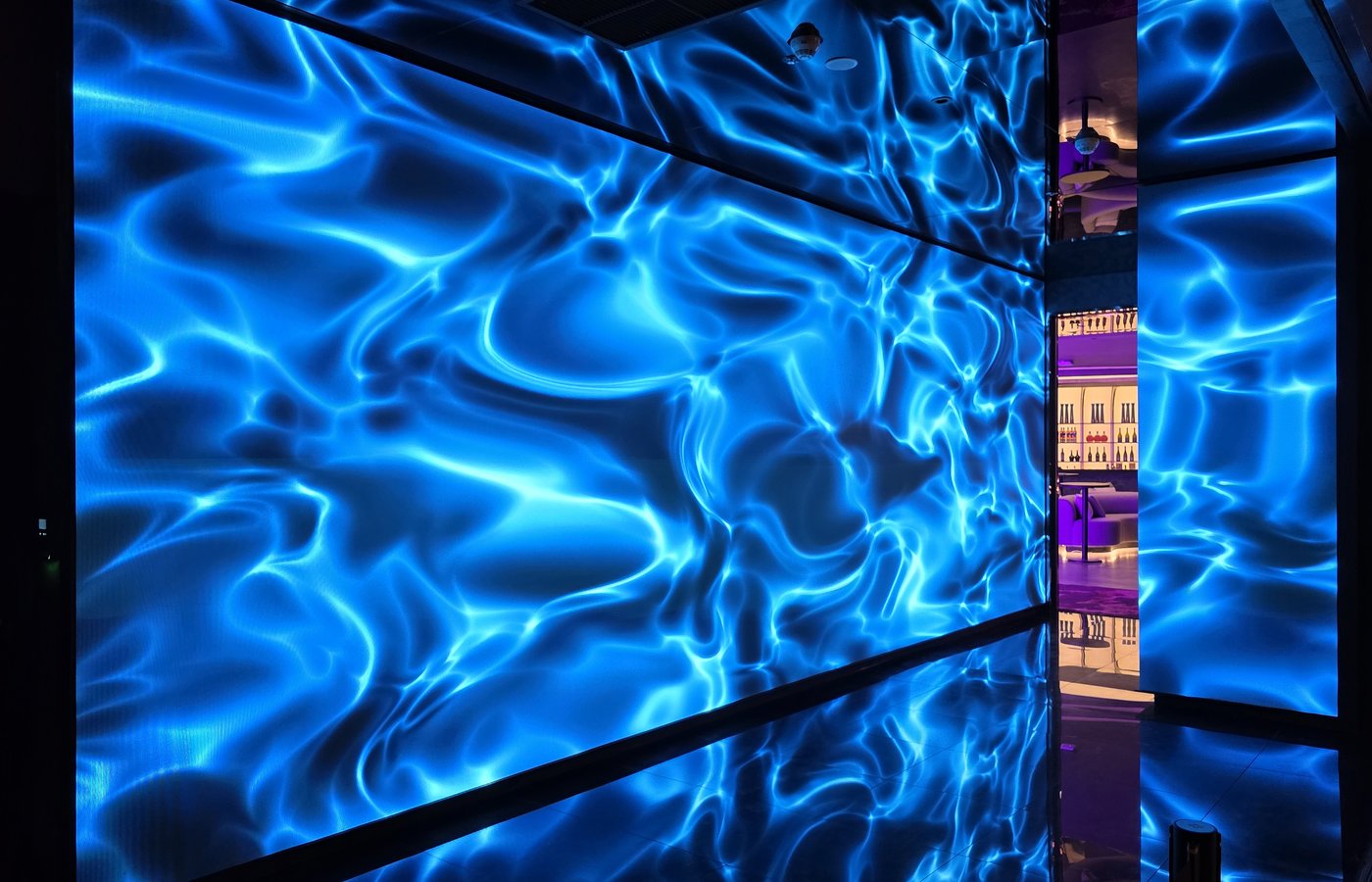 A dramatic LED corridor at Ultra Lounge, featuring immersive blue visual effects that create a striking transition into the nightlife experience beyond.